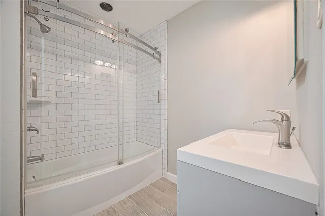 a bathroom with a shower and a sink