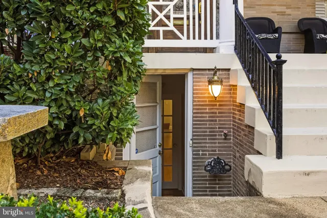 a front view of a house with plants