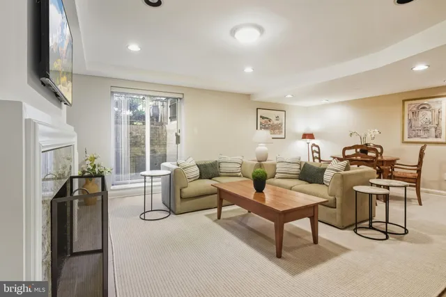 a living room with fireplace furniture and a flat screen tv