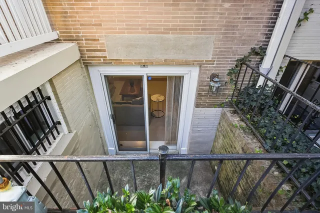 a living room with furniture a rug and a painting on the wall