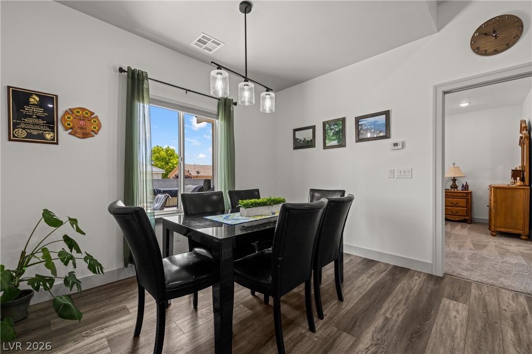 3020 Hannig Street Logandale, NV 89021 - Photo 23 of 75 This dining area features durable hardwood flooring and a stylish lighting fixture, perfect for memorable gatherings.
