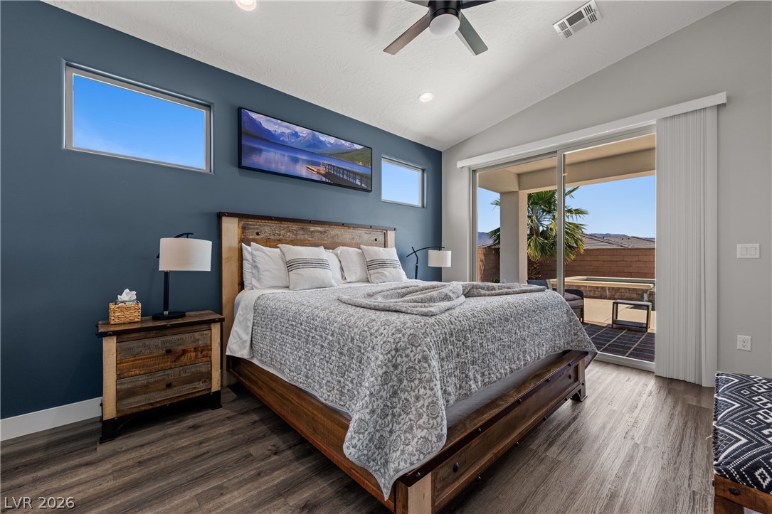 1436 Manassas Ridge Mesquite, NV 89027 - Photo 35 of 77 Retreat to this serene bedroom, where natural light pours in through generous windows and glass doors leading to a private outdoor oasis.