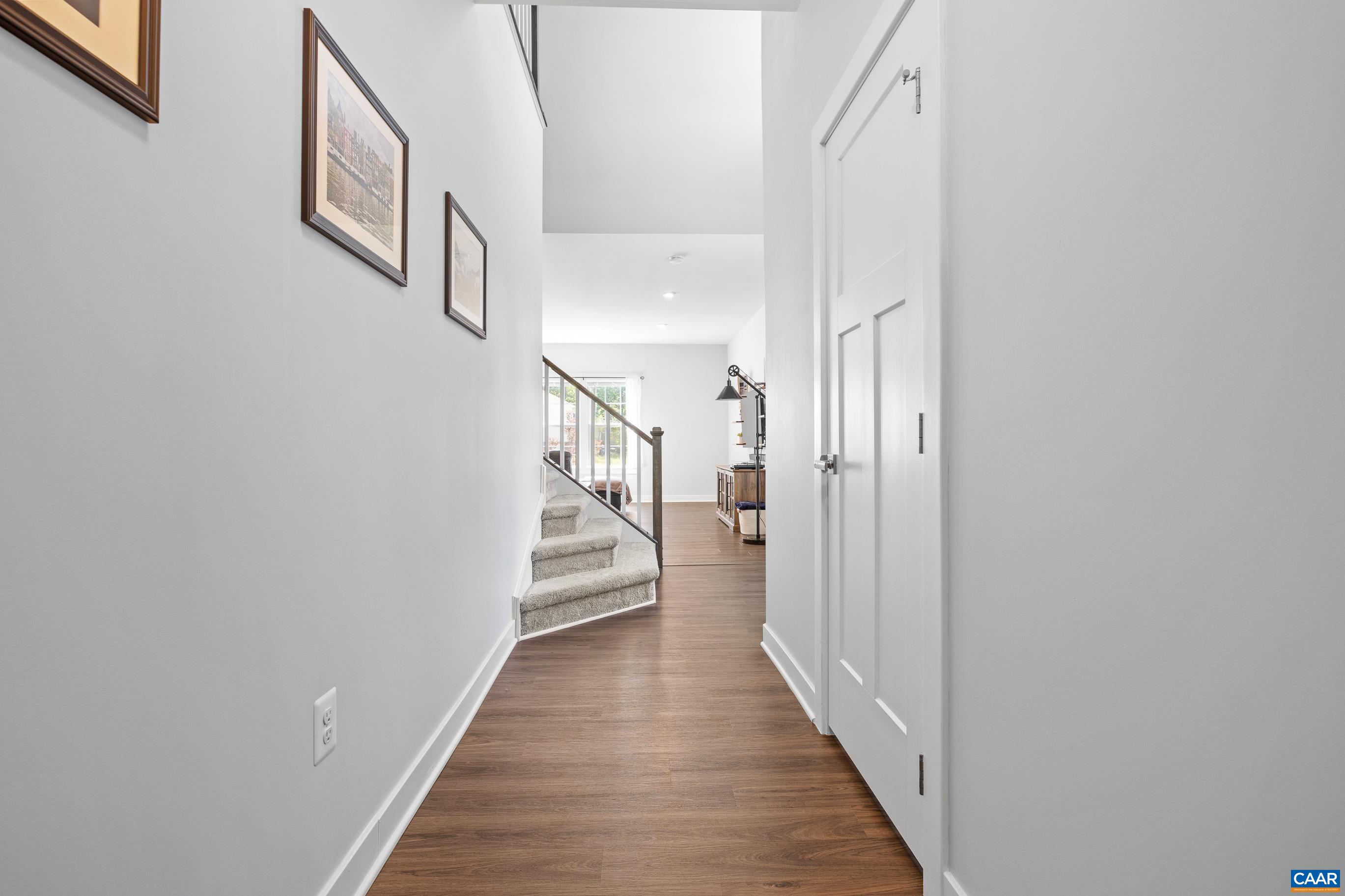 4286 Sunset Drive Charlottesville, VA 22911 - Photo 18 of 43 a view of a hallway with wooden floor and staircase