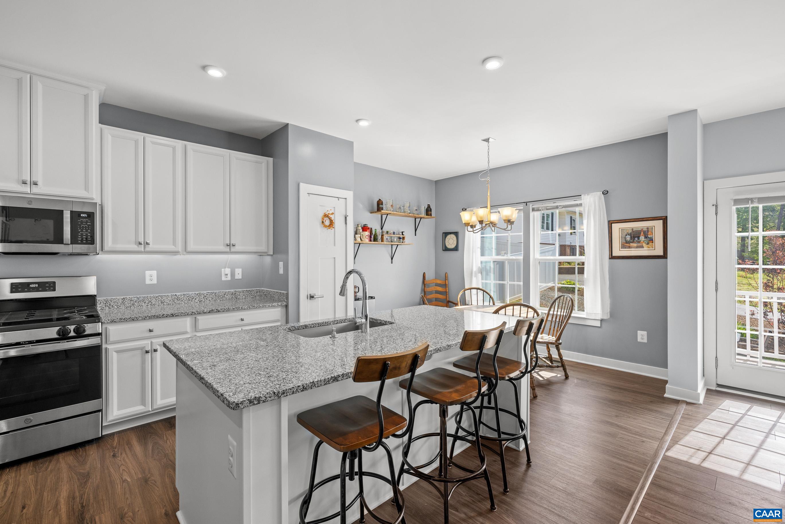 4286 Sunset Drive Charlottesville, VA 22911 - Photo 2 of 43 a view of kitchen with granite countertop kitchen island wooden floor center island and stainless steel appliances