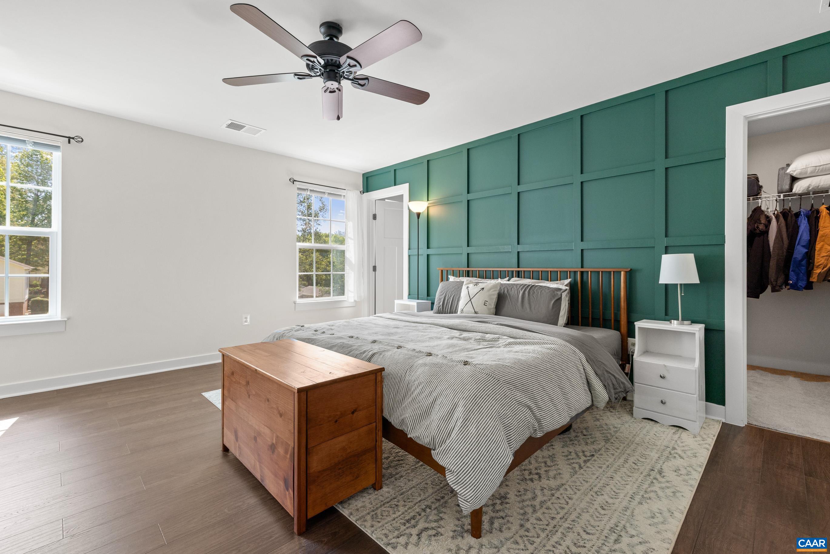 4286 Sunset Drive Charlottesville, VA 22911 - Photo 22 of 43 a spacious bedroom with a bed and a chandelier