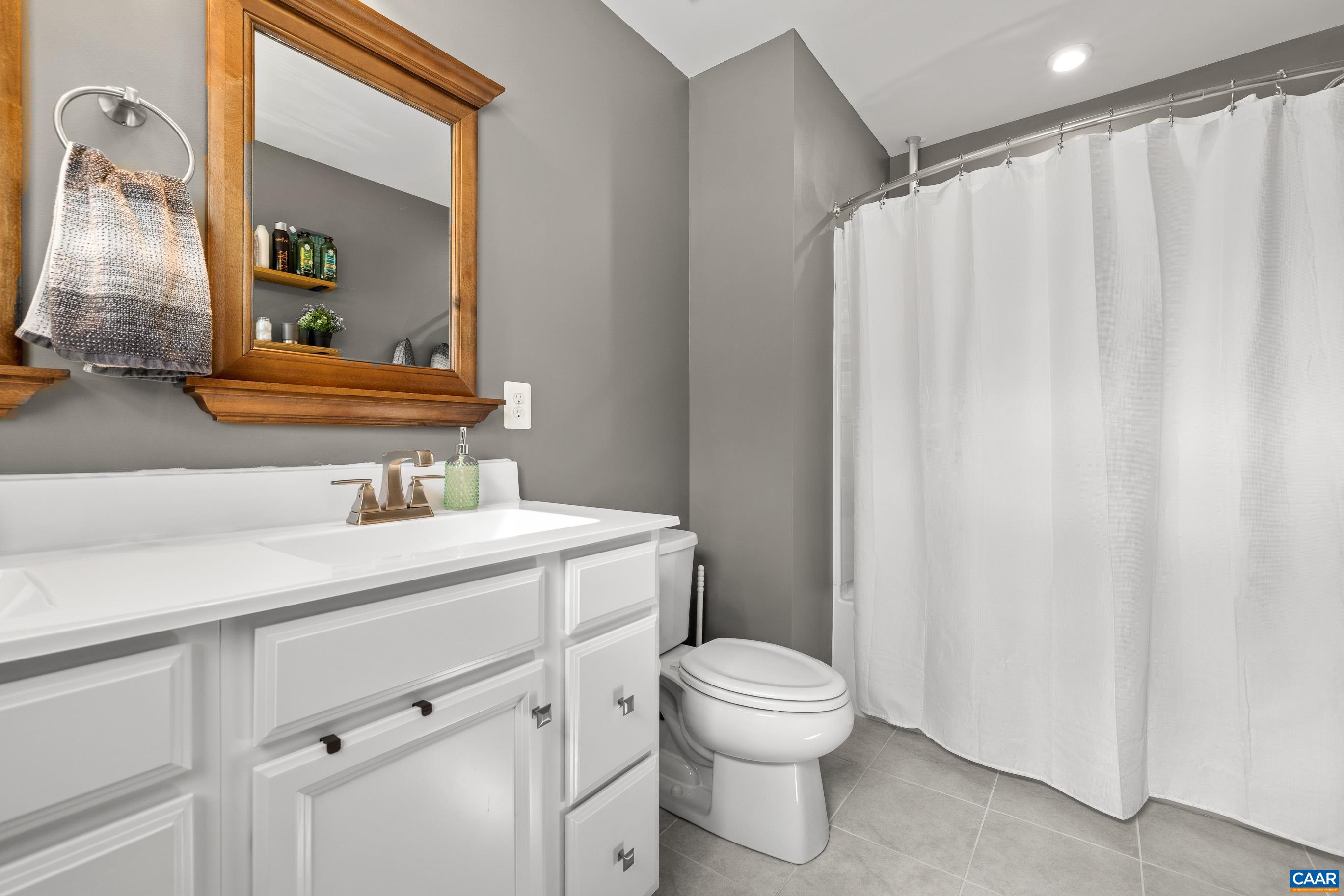 4286 Sunset Drive Charlottesville, VA 22911 - Photo 25 of 43 a bathroom with a toilet a sink and a mirror