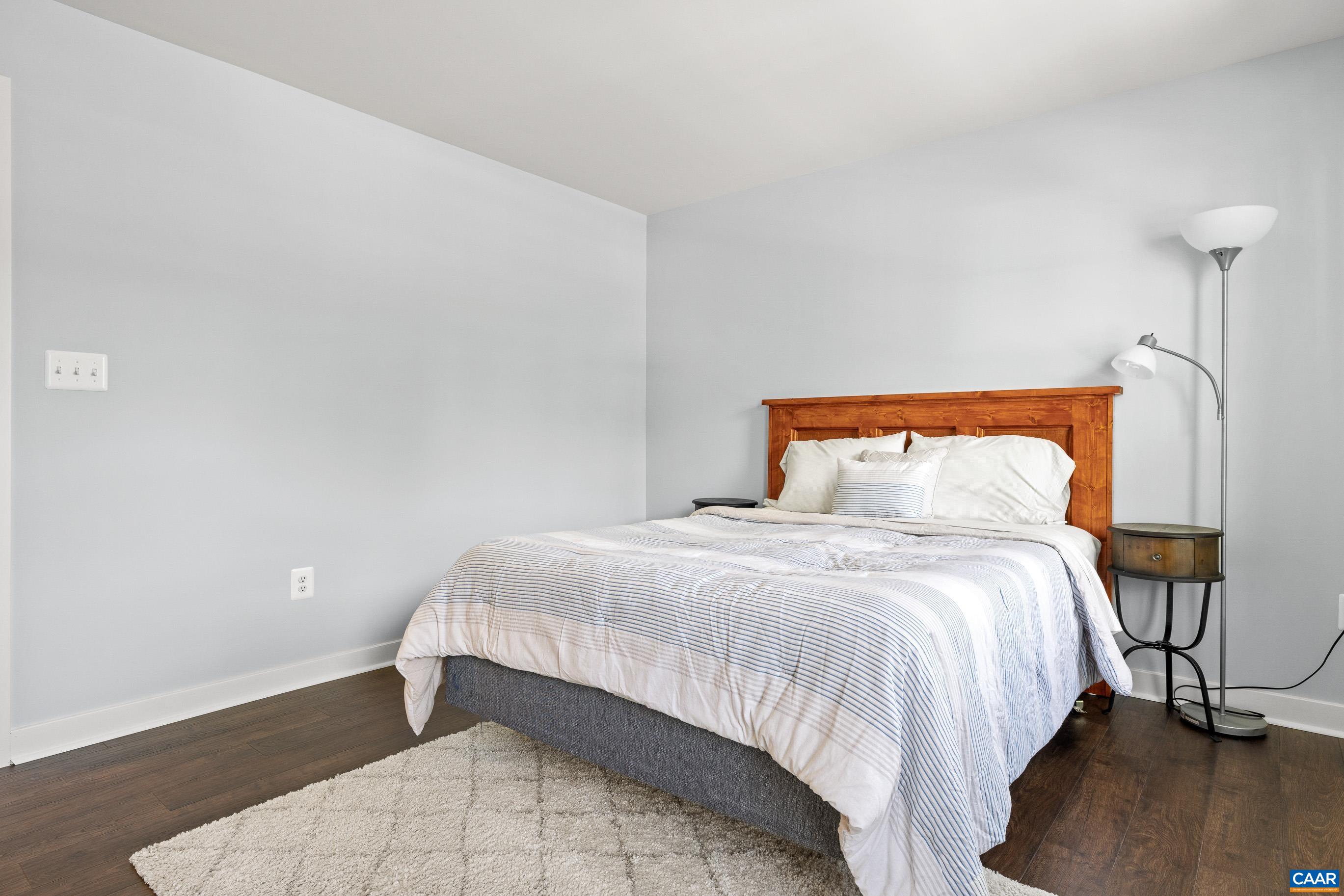 4286 Sunset Drive Charlottesville, VA 22911 - Photo 27 of 43 a bedroom with a bed and wooden floor