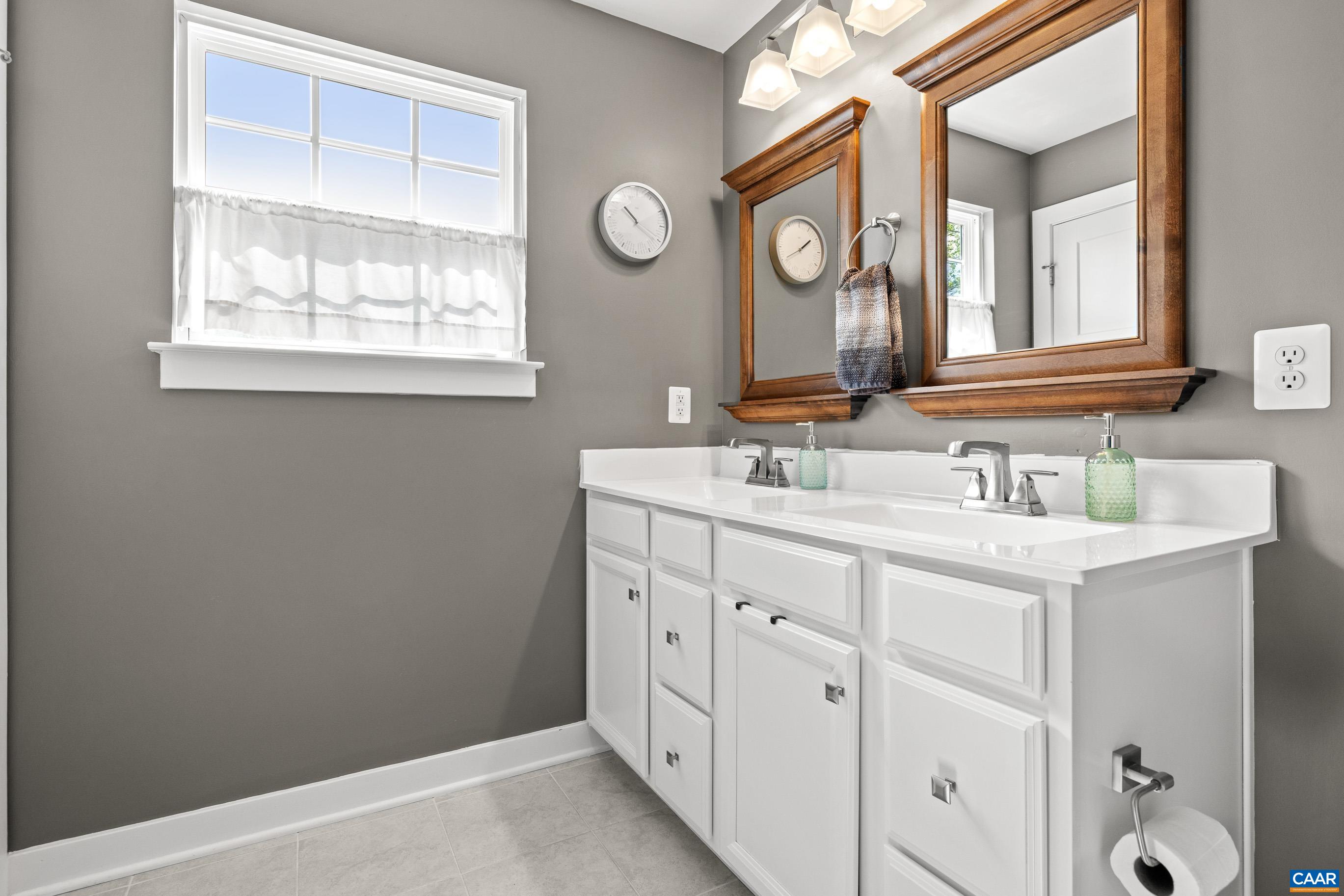 4286 Sunset Drive Charlottesville, VA 22911 - Photo 5 of 43 a bathroom with a double vanity sink and a mirror