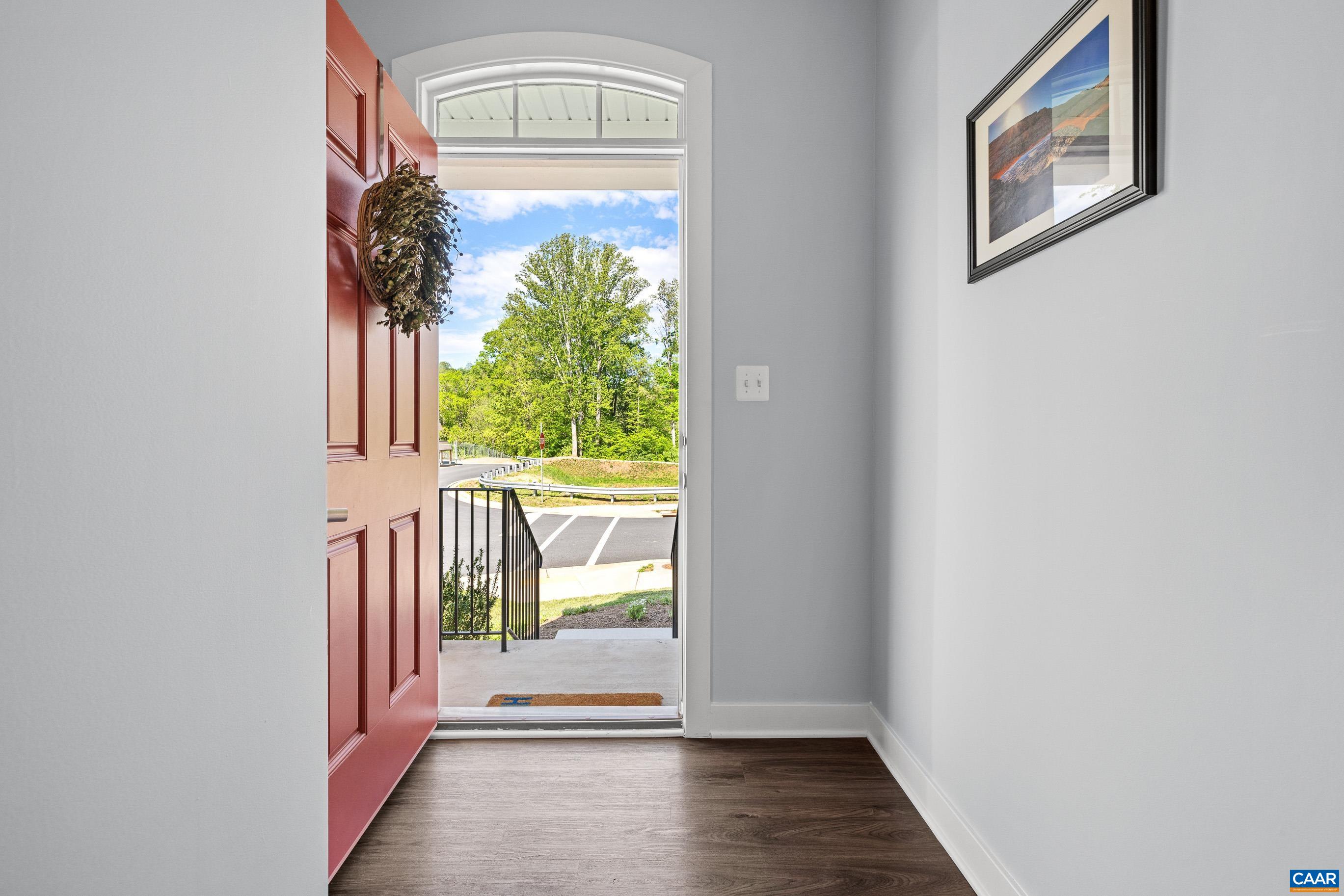 4286 Sunset Drive Charlottesville, VA 22911 - Photo 6 of 43 a view of a hallway with wooden floor and a dining room