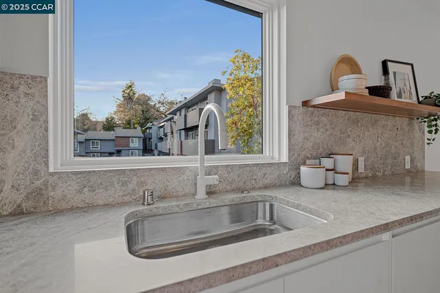 a kitchen with a refrigerator and a stove top oven