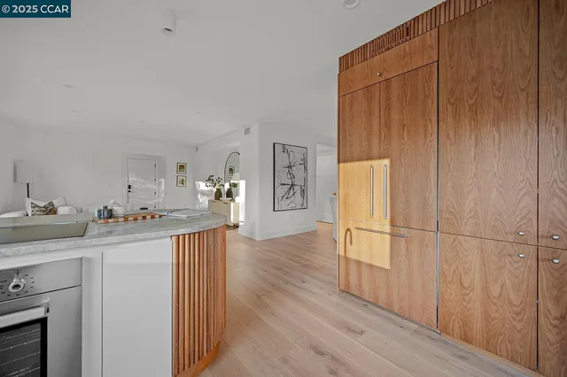 a kitchen with a refrigerator and a stove top oven