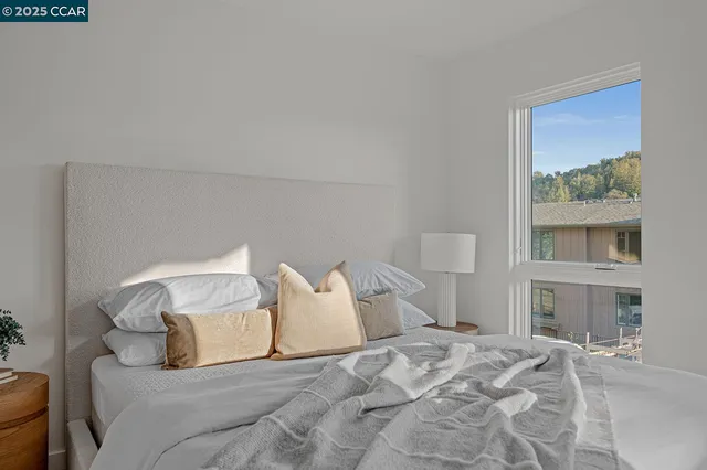 a large bed sitting in a bedroom and a large mirror