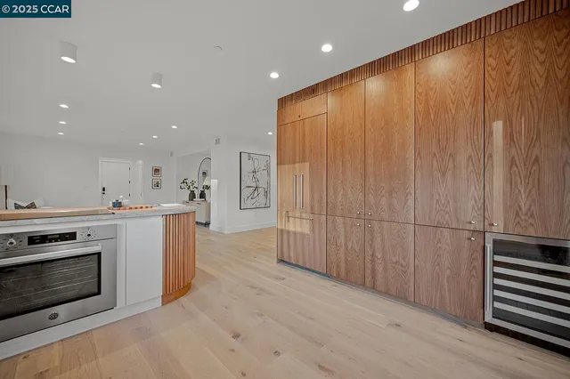 a living room with furniture a mirror and a table