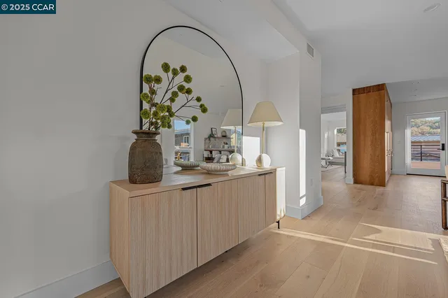 a hallway with a sink and a mirror