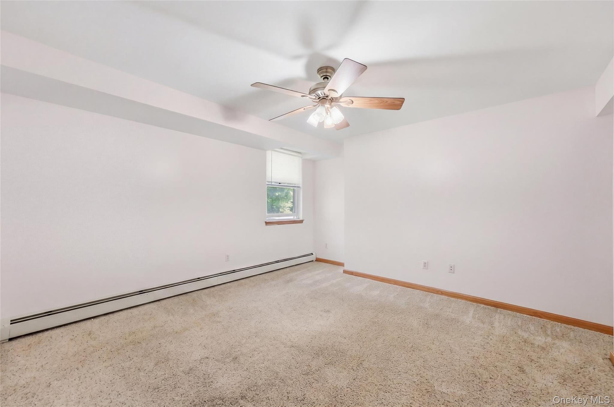 5 Horton Road Washingtonville, NY 10992 - Photo 34 of 42 an empty room with a window and a ceiling fan