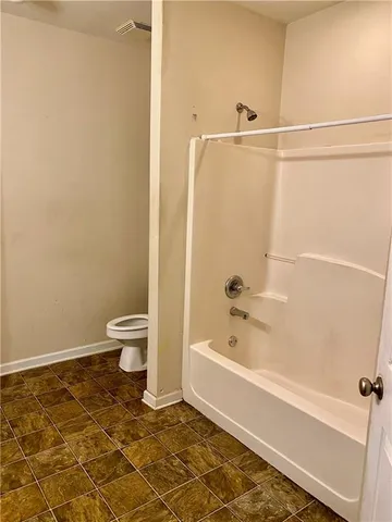 a bathroom with a toilet and a bathtub