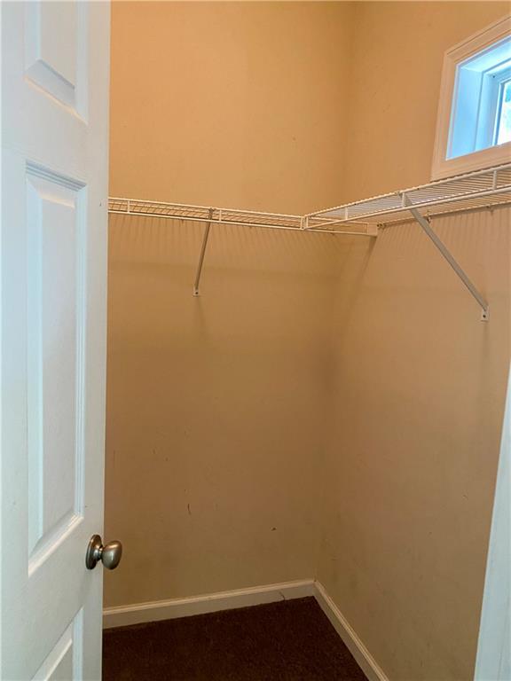 1428 Orchard Park Drive Stone Mountain, GA 30083 - Photo 18 of 19 a view of a room with racks on the wall