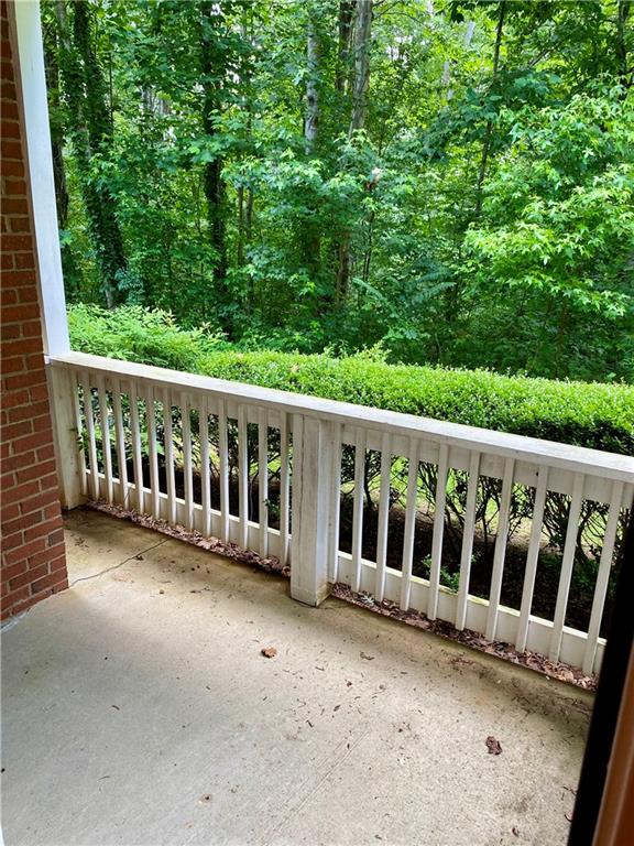 1428 Orchard Park Drive Stone Mountain, GA 30083 - Photo 6 of 19 a view of a wooden deck and a yard with big trees