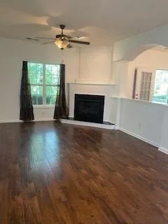 wooden floor fireplace and windows in an empty room
