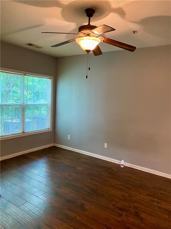 1428 Orchard Park Drive Stone Mountain, GA 30083 - Photo 10 of 19 a view of an empty room with wooden floor and a window