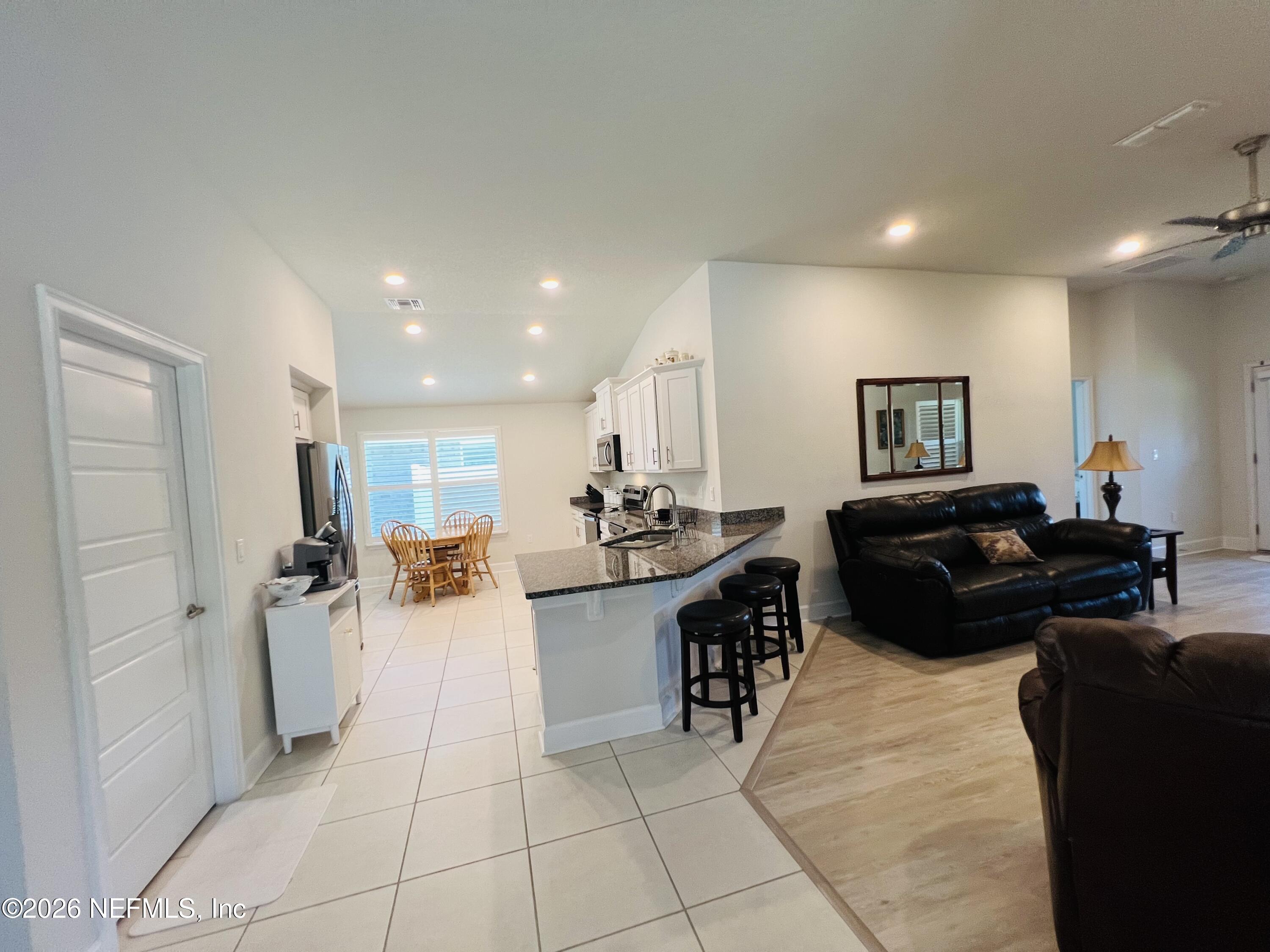 2 Rivertown Road Palm Coast, FL 32137 - Photo 49 of 80 a large living room with stainless steel appliances granite countertop a couch and a view living room
