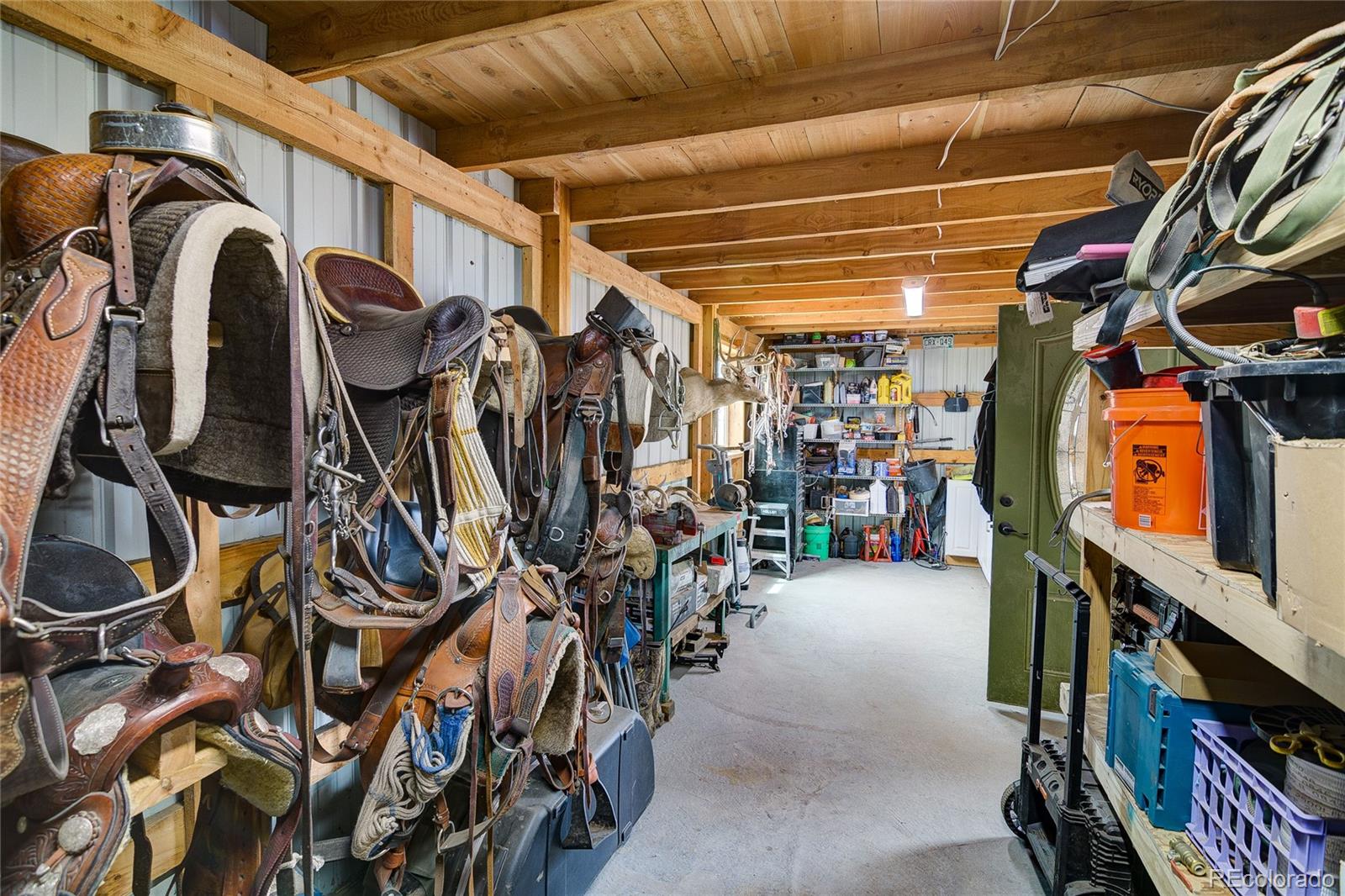 4531 East Best Road Larkspur, CO 80118 - Photo 36 of 49 a view of walk in closet with clothes and shoes