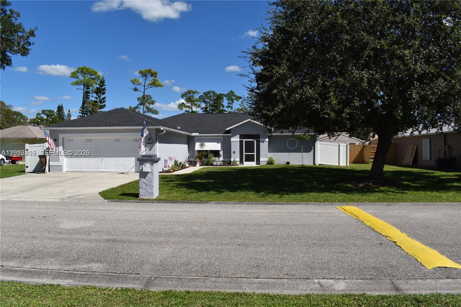 15639 Spring Line Lane Fort Myers, FL 33905 - Photo 1 of 14 a front view of a house with garden