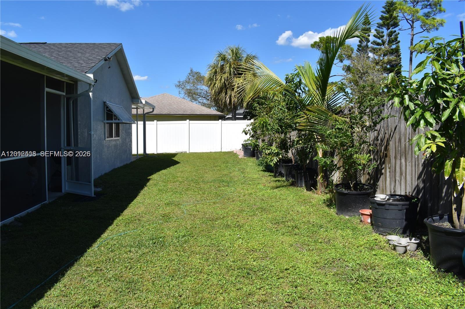 15639 Spring Line Lane Fort Myers, FL 33905 - Photo 11 of 14 a view of a house with a backyard
