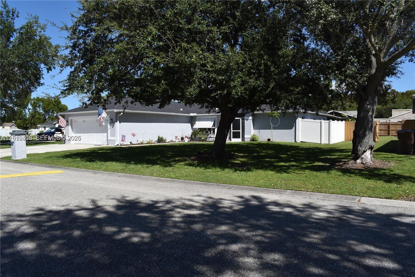 15639 Spring Line Lane Fort Myers, FL 33905 - Photo 14 of 14 a view of a house with a big yard and large trees