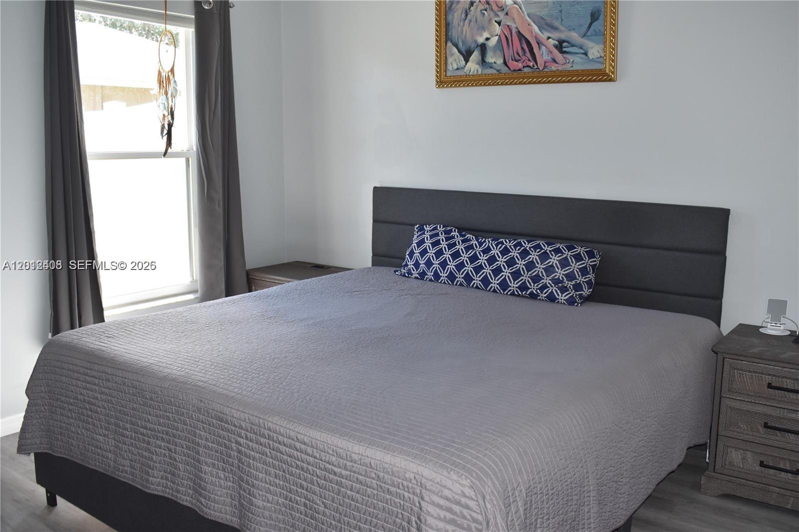 15639 Spring Line Lane Fort Myers, FL 33905 - Photo 8 of 14 a bedroom with a bed and a window