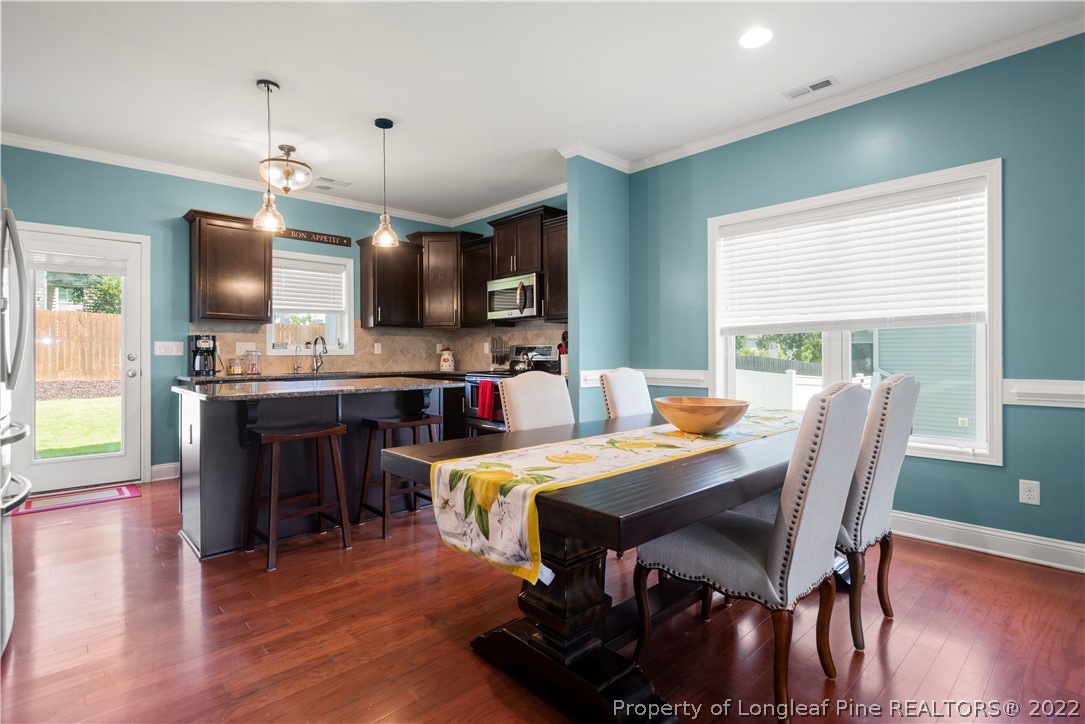 207 Samuel Nicholas Drive Cameron, NC 28326 - Photo 11 of 31 a view of a dining room with furniture window and wooden floor