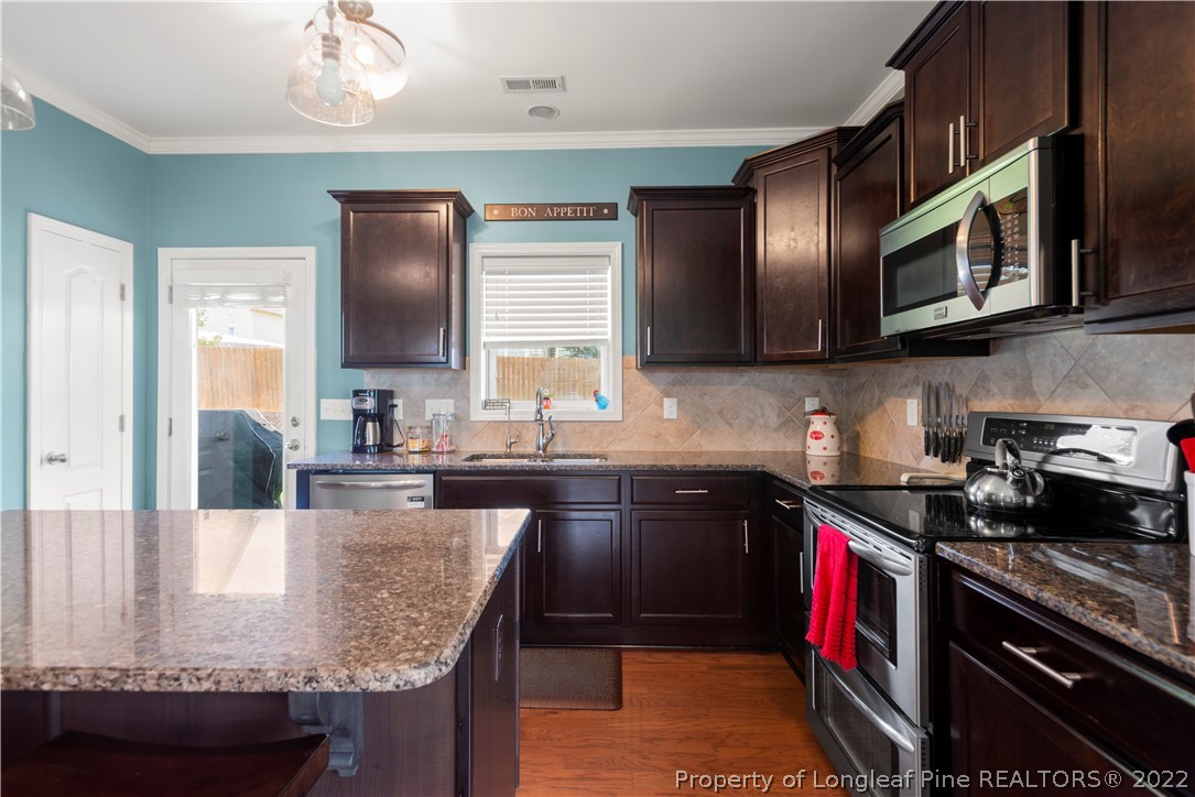 207 Samuel Nicholas Drive Cameron, NC 28326 - Photo 14 of 31 a kitchen with granite countertop lots of counter top space and stainless steel appliances