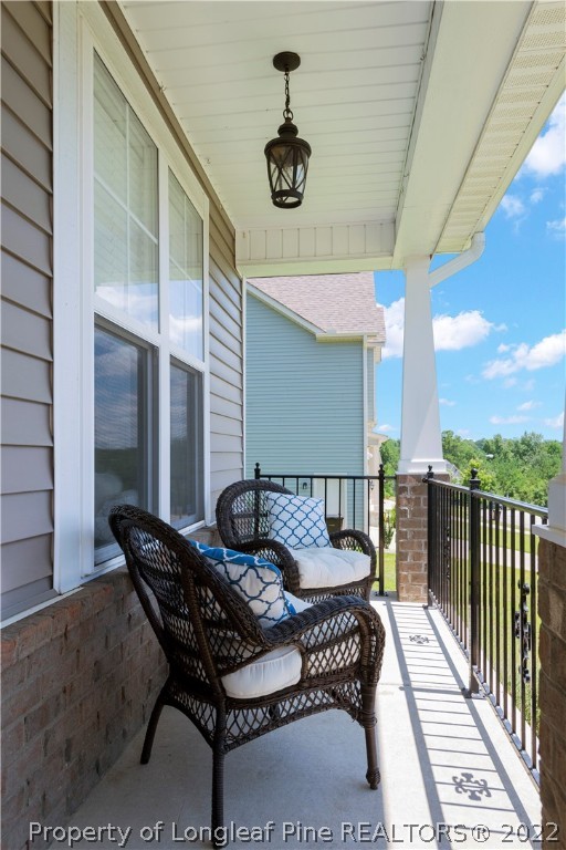 207 Samuel Nicholas Drive Cameron, NC 28326 - Photo 2 of 31 a balcony view with a seating space