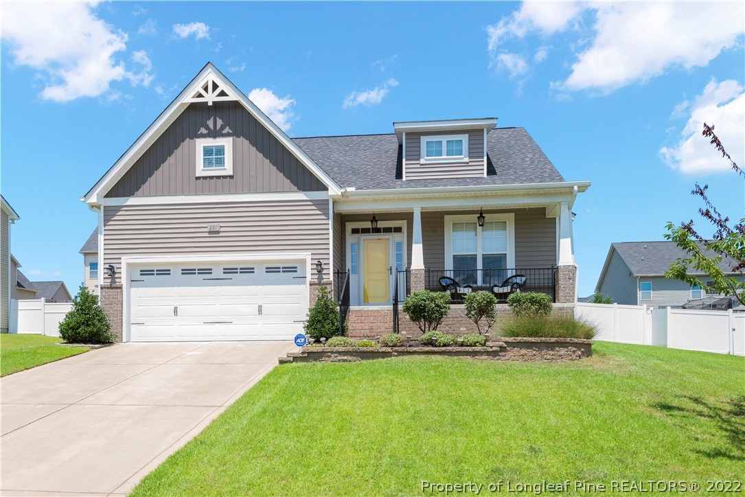 207 Samuel Nicholas Drive Cameron, NC 28326 - Photo 29 of 31 a front view of a house with a yard and garage