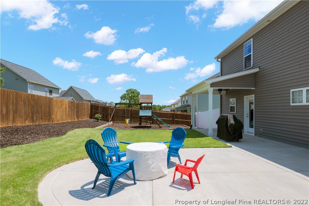 207 Samuel Nicholas Drive Cameron, NC 28326 - Photo 5 of 31 a view of a backyard with furniture and a garden