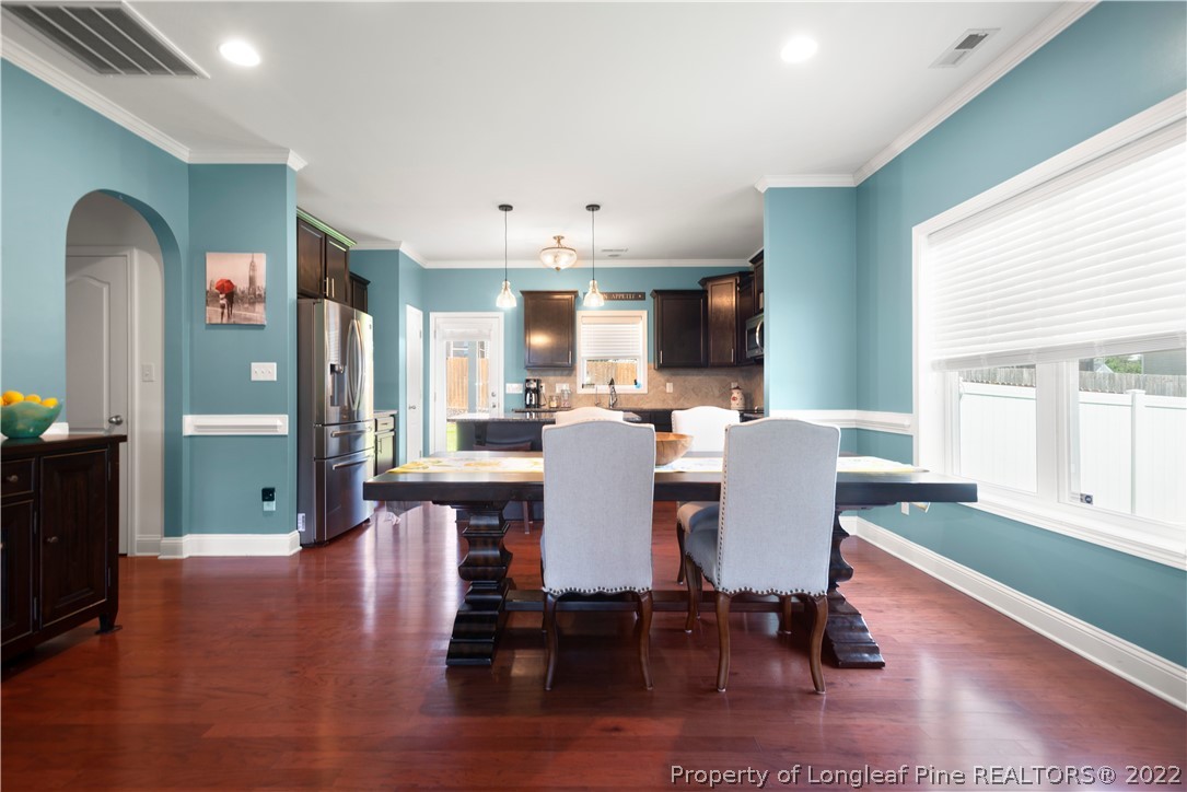 207 Samuel Nicholas Drive Cameron, NC 28326 - Photo 10 of 31 a view of a dining room with furniture window and wooden floor