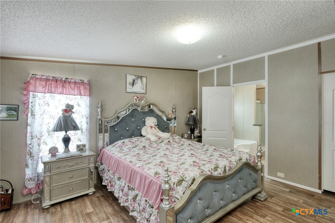 181 Pasadera Drive Elgin, TX 78621 - Photo 14 of 33 a bedroom with a bed and a dresser