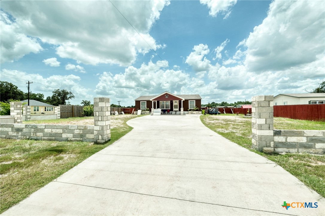 181 Pasadera Drive Elgin, TX 78621 - Photo 2 of 33 a swimming pool with yard in front of it