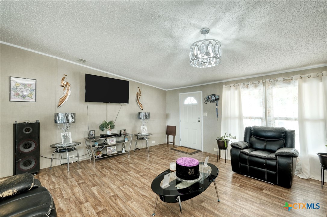 181 Pasadera Drive Elgin, TX 78621 - Photo 6 of 33 a living room with furniture and a flat screen tv