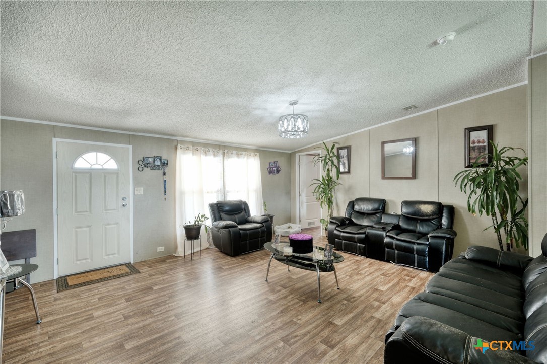 181 Pasadera Drive Elgin, TX 78621 - Photo 7 of 33 a living room with furniture and a flat screen tv