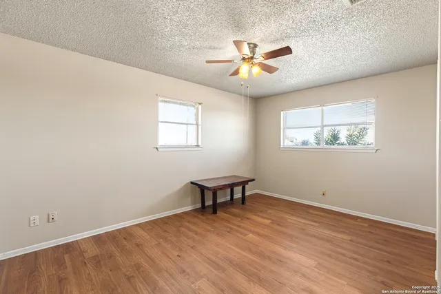 a view of a livingroom with a window and a ceiling fan