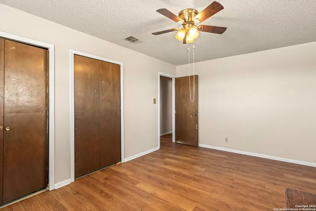 a bathroom with a granite countertop sink a toilet and mirror