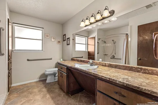a bathroom with a glass shower door