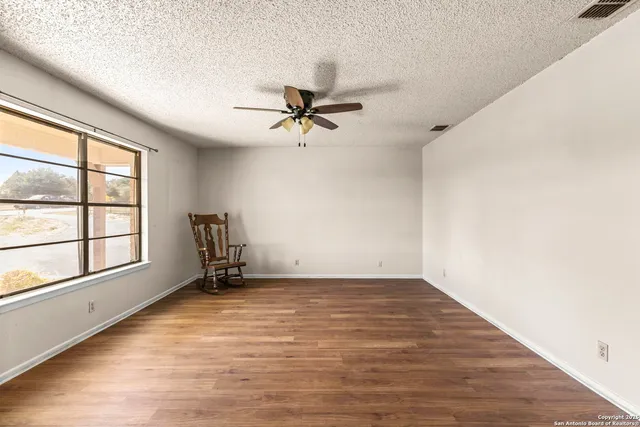a kitchen with stainless steel appliances kitchen island granite countertop a table chairs and a wooden cabinets