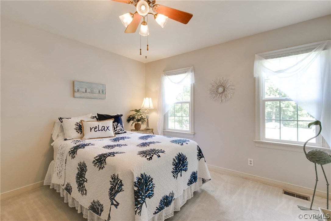 5302 Chestnut Bluff Road Midlothian, VA 23112 - Photo 45 of 50 a bedroom with a bed and a chandelier