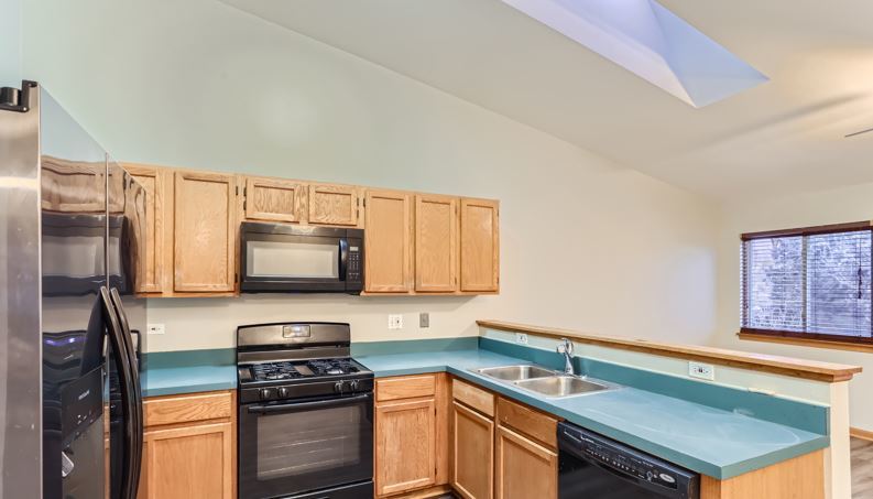 Undisclosed Address Round Lake Beach, IL 60073 - Photo 2 of 10 a kitchen with stainless steel appliances a stove microwave and sink
