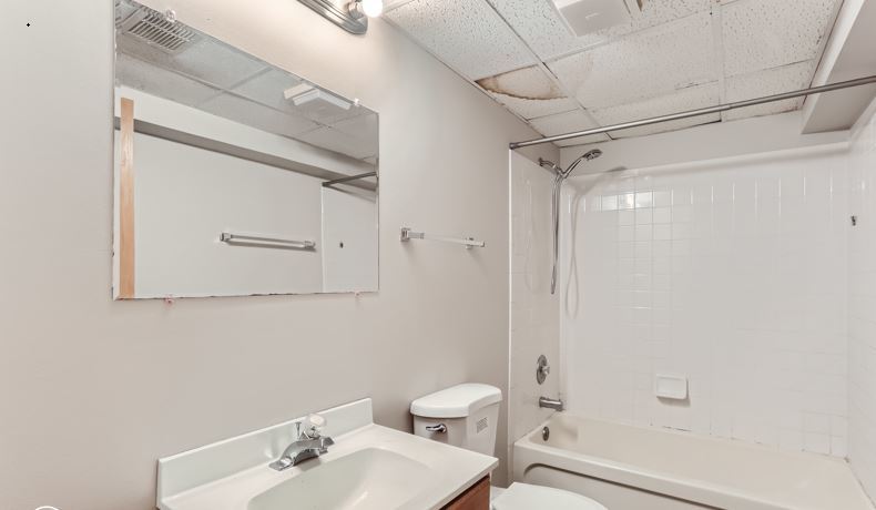 Undisclosed Address Round Lake Beach, IL 60073 - Photo 7 of 10 a bathroom with a sink mirror and toilet