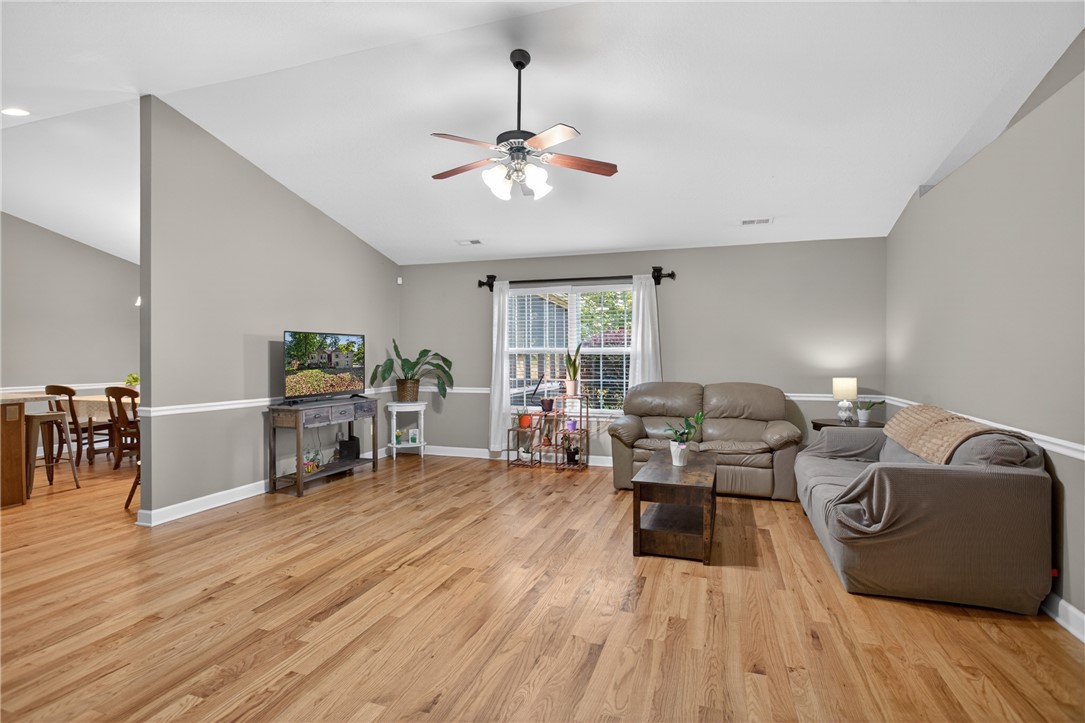 151 Towne Creek Trail Anderson, SC 29621 - Photo 2 of 49 Vast hardwood flooring flows through this comfortable living space, featuring high vaulted ceilings and a warm atmosphere.