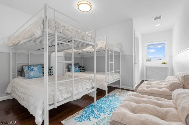 a bed room with a bed and a view of living room