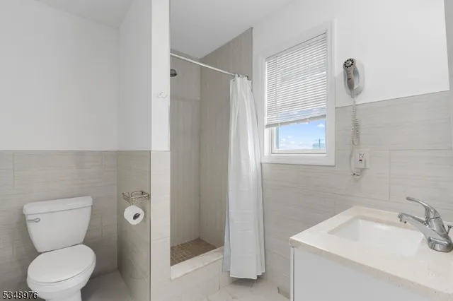 a bathroom with a toilet sink and shower